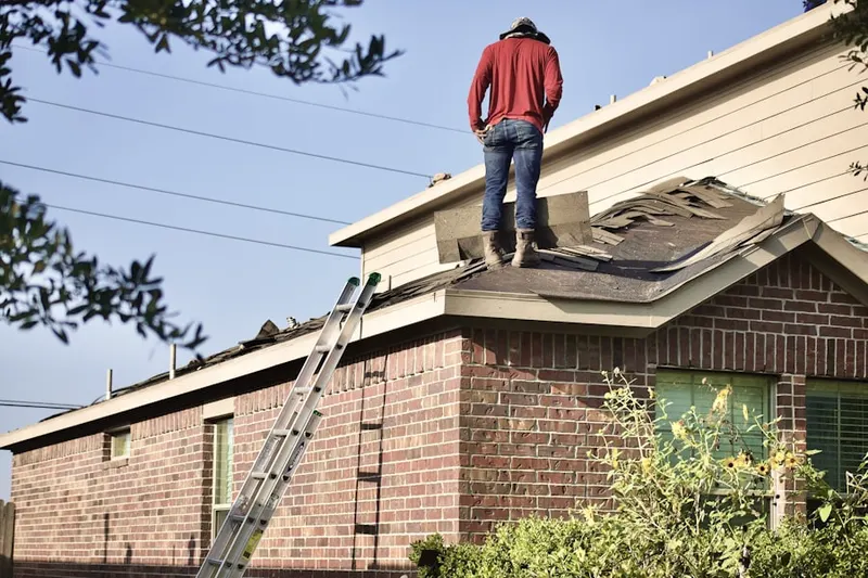 Professional roofer working on a residential roof in Suburban Acres